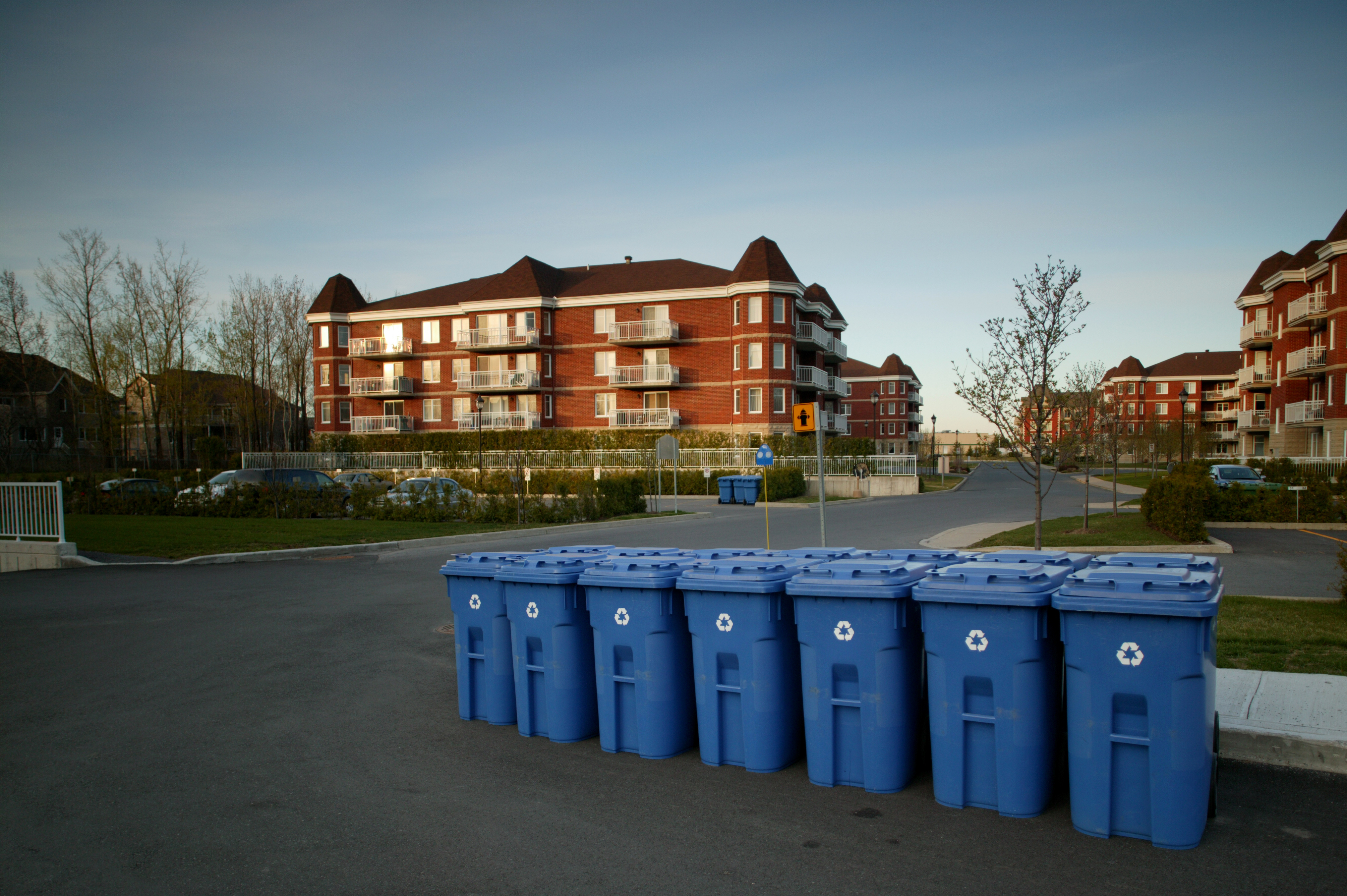 Condo building exterior with recycling bins