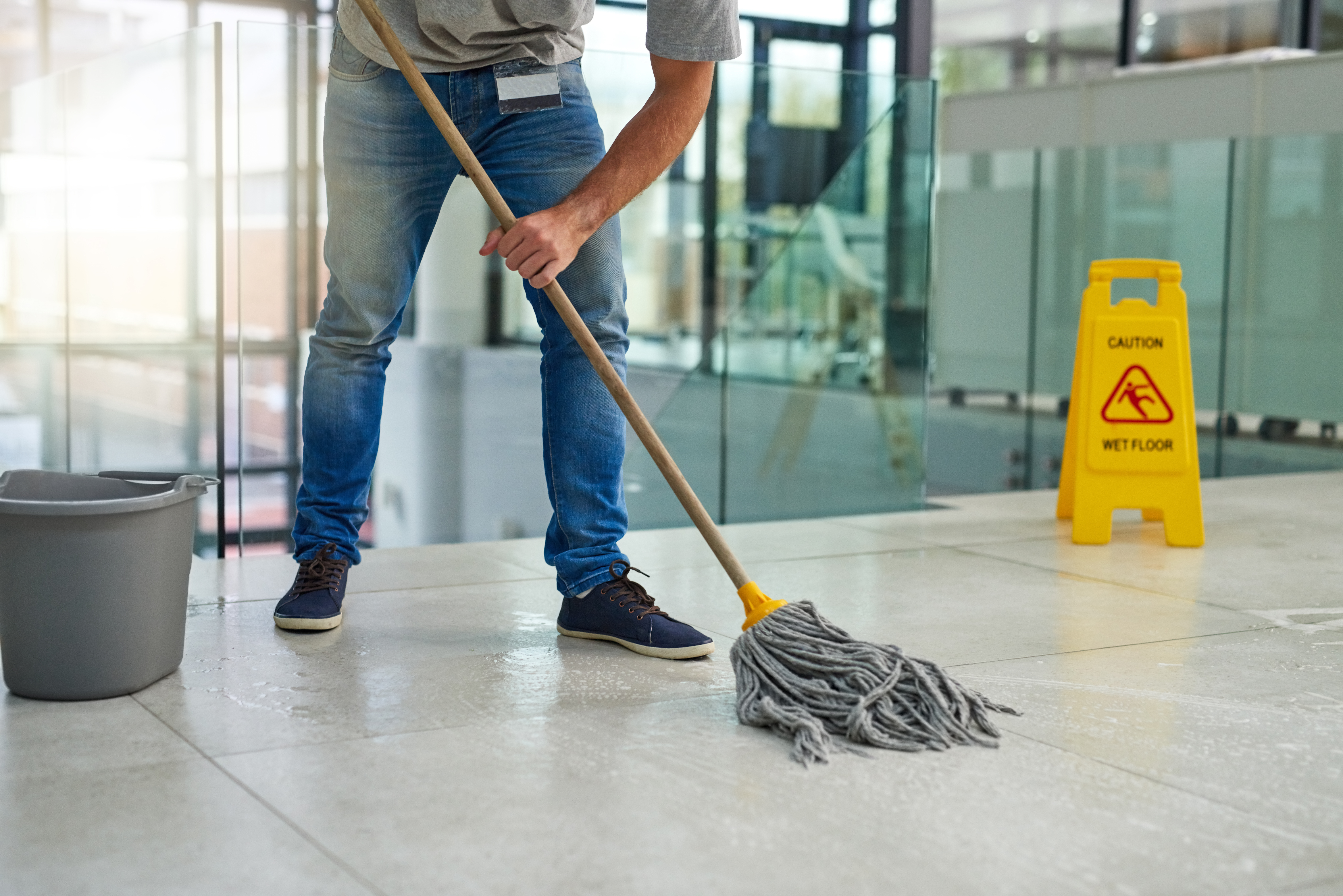 Cleaner mopping commercial entrance floor